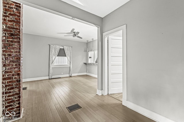 2006 Lexington Ave, Indianapolis, IN 46203 - spare room with baseboards, a ceiling fan, visible vents, and hardwood / wood-style flooring