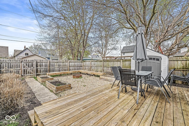2006 Lexington Ave, Indianapolis, IN 46203 - deck featuring an outbuilding, a shed, a vegetable garden, a fenced backyard, and outdoor dining area
