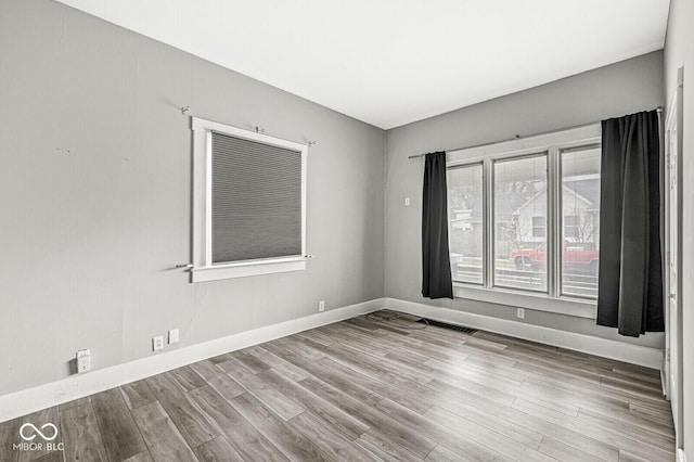2006 Lexington Ave, Indianapolis, IN 46203 - unfurnished room with visible vents, baseboards, and wood finished floors
