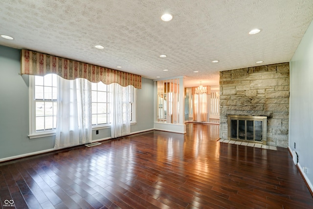 6047 W 56th St, Indianapolis, IN 46254 - unfurnished living room featuring wood finished floors, a notable chandelier, a textured ceiling, and visible vents