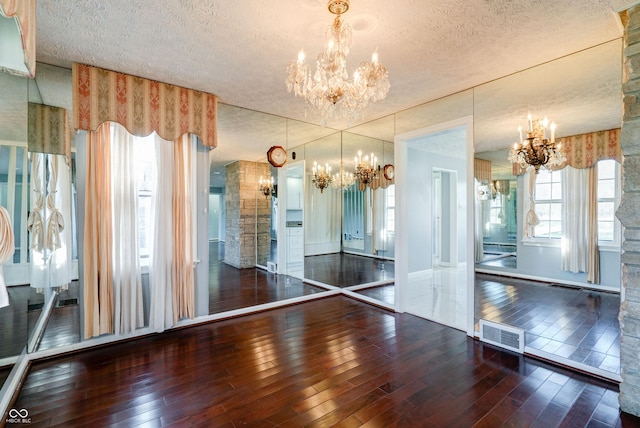 6047 W 56th St, Indianapolis, IN 46254 - interior space with hardwood / wood-style flooring, a chandelier, and visible vents