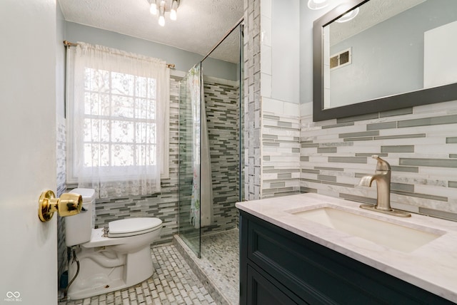 6047 W 56th St, Indianapolis, IN 46254 - bathroom with toilet, a shower stall, a textured ceiling, tile patterned flooring, and visible vents