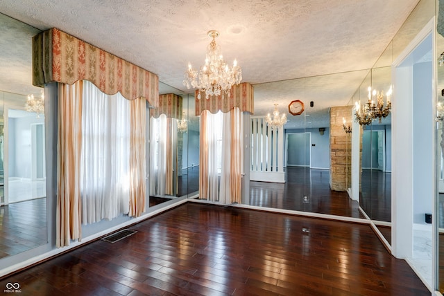 6047 W 56th St, Indianapolis, IN 46254 - interior space with a textured ceiling, hardwood / wood-style flooring, and an inviting chandelier