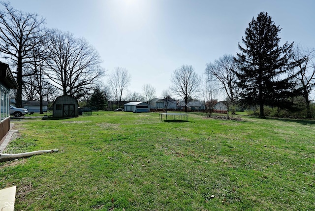 6047 W 56th St, Indianapolis, IN 46254 - view of yard with a shed, an outdoor structure, and a trampoline