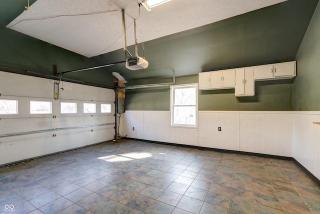 6047 W 56th St, Indianapolis, IN 46254 - garage with a wainscoted wall and a garage door opener