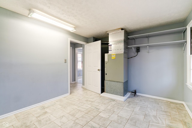 6047 W 56th St, Indianapolis, IN 46254 - basement with baseboards and a textured ceiling