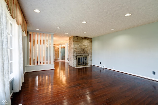 6047 W 56th St, Indianapolis, IN 46254 - unfurnished living room featuring a textured ceiling, baseboards, a fireplace, wood finished floors, and recessed lighting