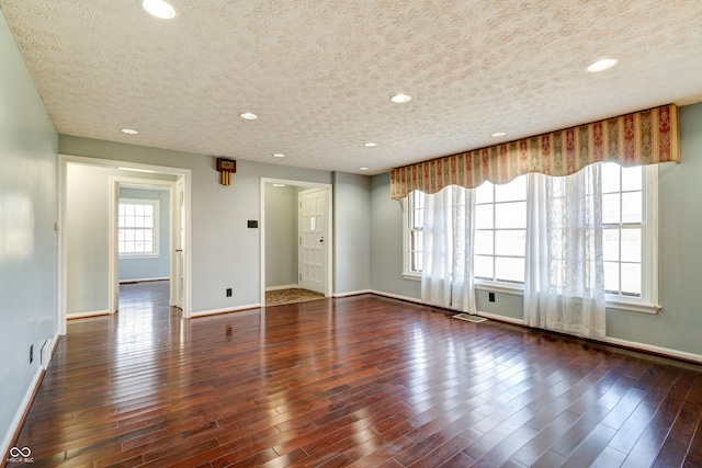 6047 W 56th St, Indianapolis, IN 46254 - unfurnished room featuring baseboards, visible vents, wood finished floors, and a textured ceiling
