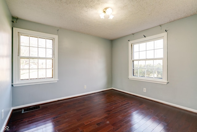 6047 W 56th St, Indianapolis, IN 46254 - unfurnished room with hardwood / wood-style floors, plenty of natural light, and visible vents