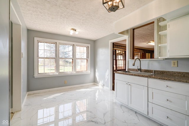 6047 W 56th St, Indianapolis, IN 46254 - bathroom with marble finish floor, baseboards, vanity, and a textured ceiling