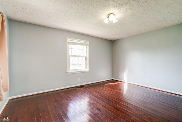 6047 W 56th St, Indianapolis, IN 46254 - spare room with baseboards, visible vents, a textured ceiling, and hardwood / wood-style floors