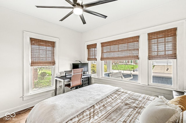 5028 Graceland Ave, Indianapolis, IN 46208 - bedroom with baseboards, ceiling fan, multiple windows, and wood finished floors