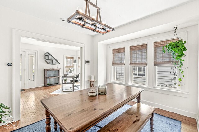 5028 Graceland Ave, Indianapolis, IN 46208 - dining area featuring baseboards, wood finished floors, and a notable chandelier