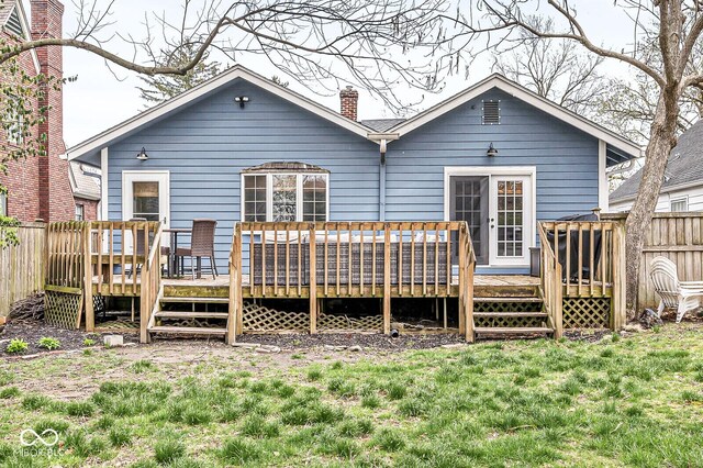 5028 Graceland Ave, Indianapolis, IN 46208 - back of property featuring fence, a wooden deck, a chimney, and a yard