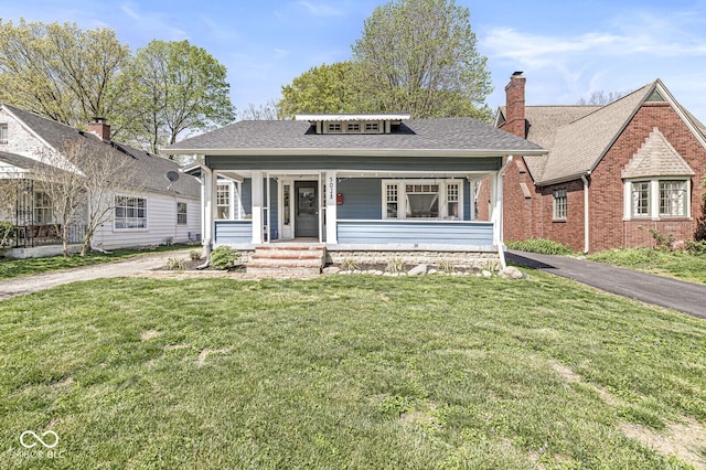 5028 Graceland Ave, Indianapolis, IN 46208 - bungalow with a front lawn, aphalt driveway, a chimney, a shingled roof, and a porch
