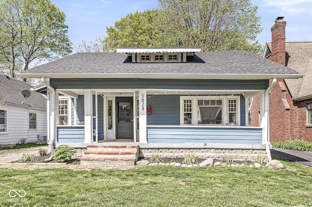 5028 Graceland Ave, Indianapolis, IN 46208 - bungalow-style house with a porch, a shingled roof, and a front yard