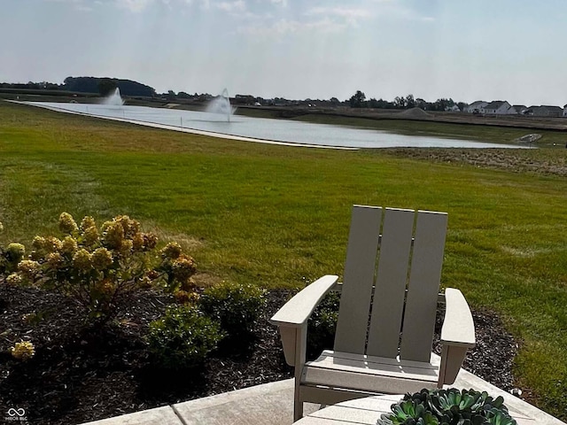 surrounding community featuring a water view and a lawn