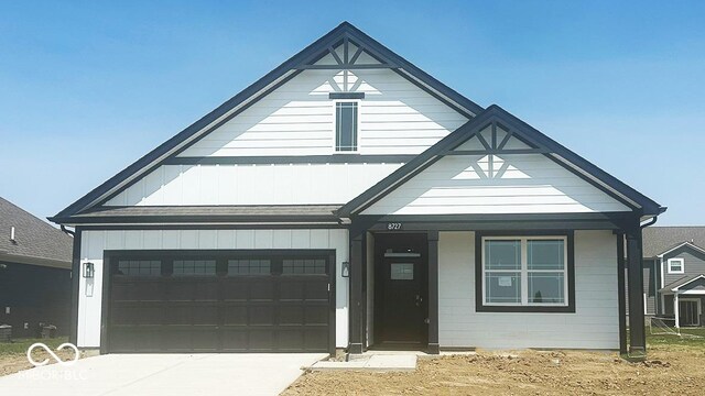 8727 Duncan St, Fortville, IN 46040 - view of front of home featuring driveway, covered porch, and board and batten siding