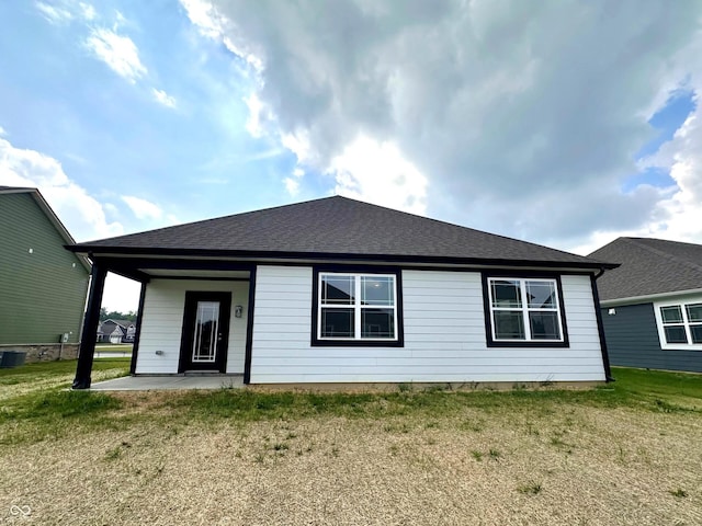 8727 Duncan St, Fortville, IN 46040 - rear view of house with a lawn, a shingled roof, and a patio area