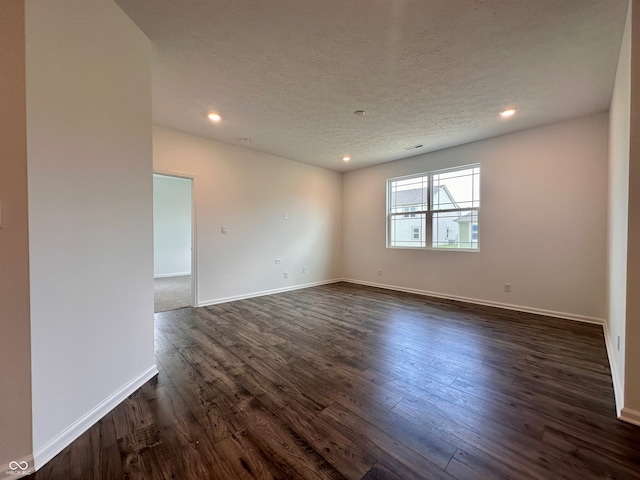8727 Duncan St, Fortville, IN 46040 - spare room featuring dark wood-style floors, recessed lighting, and a textured ceiling