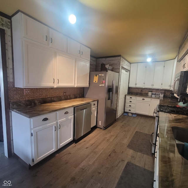 1024 Foltz St, Indianapolis, IN 46241 - kitchen with white cabinets, decorative backsplash, dark wood-type flooring, and stainless steel appliances