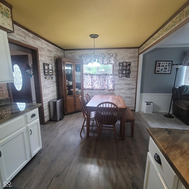 1024 Foltz St, Indianapolis, IN 46241 - dining area featuring a wainscoted wall, dark wood-style floors, crown molding, and a notable chandelier