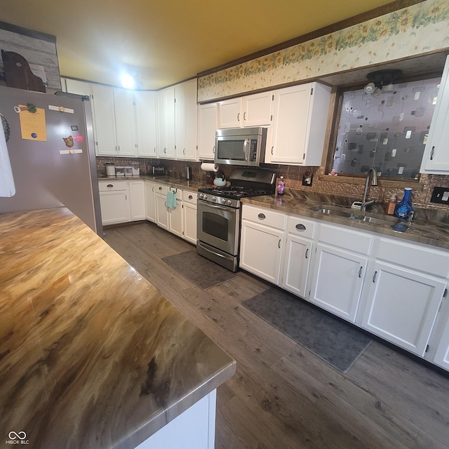 1024 Foltz St, Indianapolis, IN 46241 - kitchen featuring dark wood-style flooring, white cabinetry, a sink, and stainless steel appliances