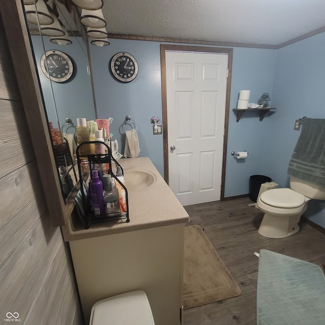 1024 Foltz St, Indianapolis, IN 46241 - bathroom featuring toilet, a textured ceiling, baseboards, and wood finished floors