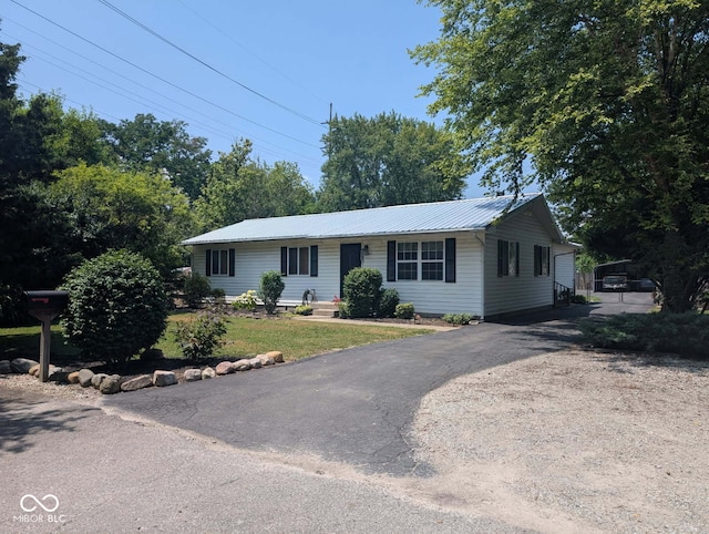 1024 Foltz St, Indianapolis, IN 46241 - ranch-style house with asphalt driveway, a metal roof, and a front lawn