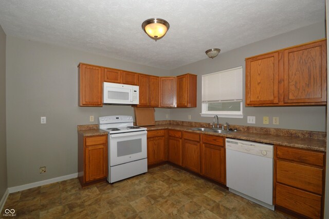 5406 Shamus Dr, Indianapolis, IN 46235 - kitchen with white appliances, a sink, brown cabinets, and a textured ceiling