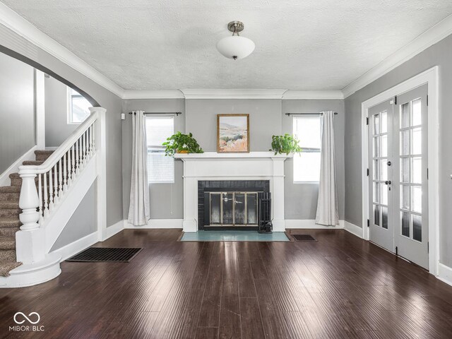 317 E 37th St, Indianapolis, IN 46205 - unfurnished living room with ornamental molding, visible vents, stairway, and hardwood / wood-style flooring