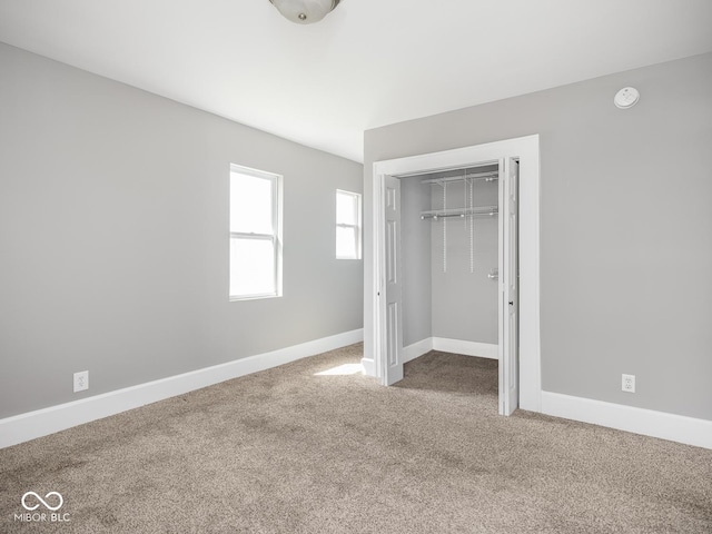 317 E 37th St, Indianapolis, IN 46205 - unfurnished bedroom with baseboards, carpet flooring, and a closet