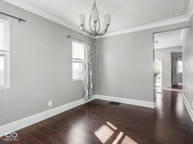 317 E 37th St, Indianapolis, IN 46205 - empty room featuring wood-type flooring, a textured ceiling, visible vents, ornamental molding, and an inviting chandelier