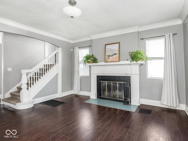 317 E 37th St, Indianapolis, IN 46205 - unfurnished living room with visible vents, wood finished floors, stairway, and a healthy amount of sunlight