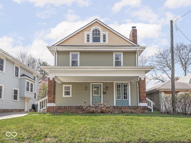 317 E 37th St, Indianapolis, IN 46205 - american foursquare style home featuring covered porch, a chimney, and a front lawn