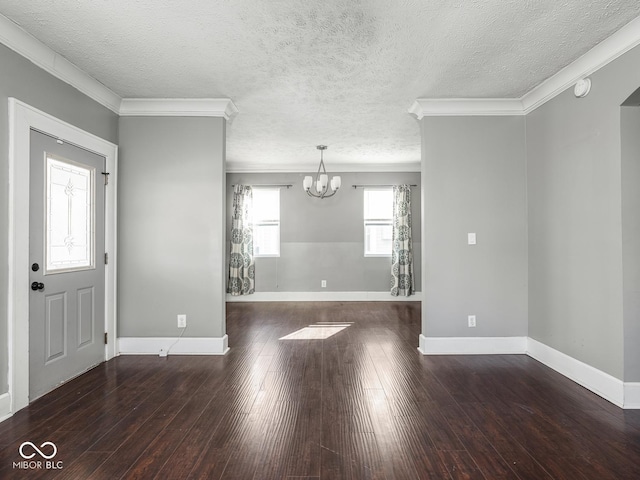 317 E 37th St, Indianapolis, IN 46205 - foyer entrance with a textured ceiling, a chandelier, baseboards, ornamental molding, and hardwood / wood-style floors
