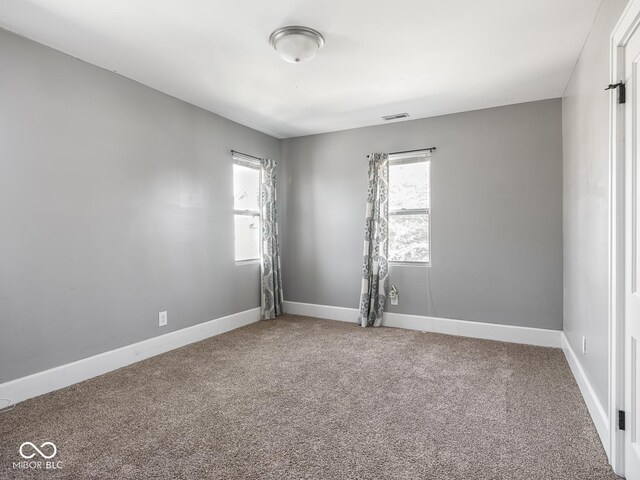 317 E 37th St, Indianapolis, IN 46205 - carpeted empty room with baseboards, a healthy amount of sunlight, and visible vents