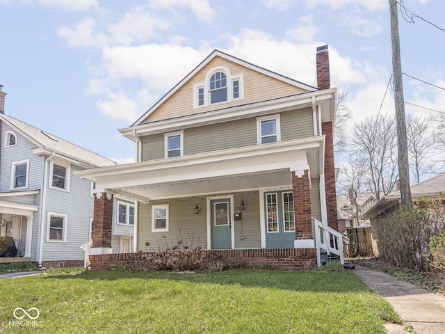 317 E 37th St, Indianapolis, IN 46205 - american foursquare style home featuring covered porch, a chimney, and a front yard