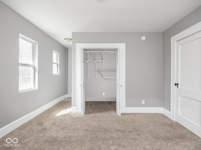 317 E 37th St, Indianapolis, IN 46205 - unfurnished bedroom with baseboards, carpet flooring, and a closet