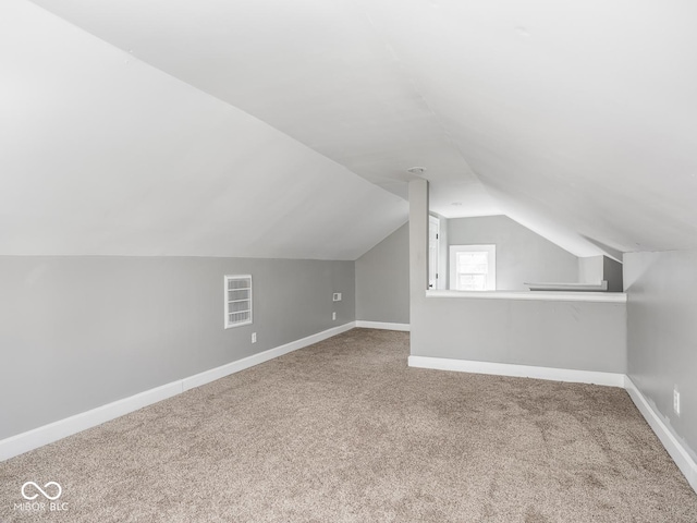 317 E 37th St, Indianapolis, IN 46205 - bonus room with baseboards, lofted ceiling, visible vents, and carpet