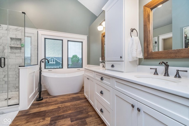 2353 Woodcreek Crossing Blvd, Avon, IN 46123 - full bath featuring double vanity, a shower stall, vaulted ceiling, a freestanding bath, and wood finished floors