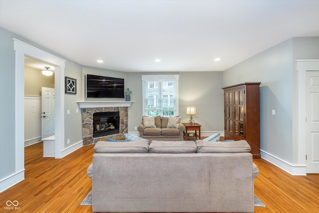 2353 Woodcreek Crossing Blvd, Avon, IN 46123 - living room featuring light wood finished floors, a fireplace, recessed lighting, and baseboards