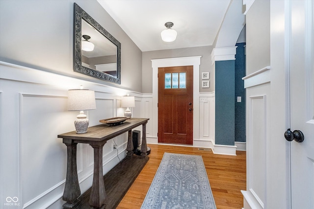2353 Woodcreek Crossing Blvd, Avon, IN 46123 - entrance foyer featuring wainscoting, a decorative wall, and light wood-style floors