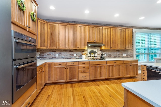 2353 Woodcreek Crossing Blvd, Avon, IN 46123 - kitchen with under cabinet range hood, black appliances, light countertops, tasteful backsplash, and recessed lighting