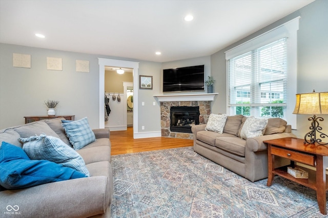2353 Woodcreek Crossing Blvd, Avon, IN 46123 - living area with wood finished floors, recessed lighting, a stone fireplace, and baseboards