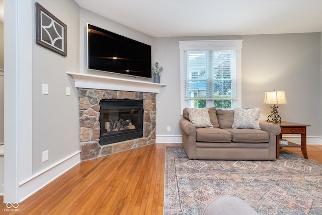 2353 Woodcreek Crossing Blvd, Avon, IN 46123 - living area featuring wood finished floors, a fireplace, and baseboards