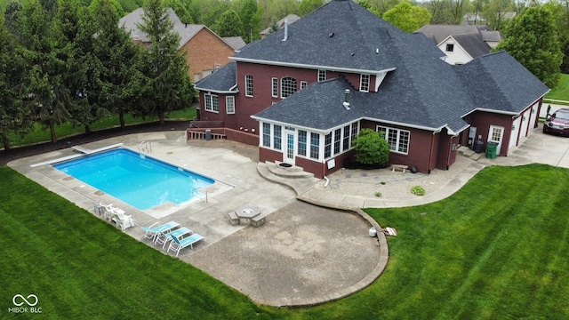 633 Foxboro Dr, Avon, IN 46123 - rear view of house with roof with shingles, a lawn, an outdoor pool, a sunroom, and a patio
