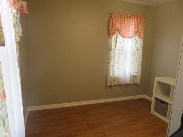 interior space featuring baseboards and wood finished floors