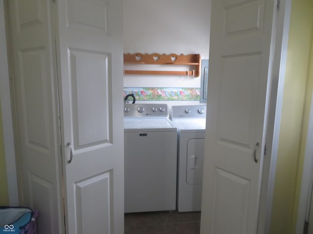 washroom with laundry area, washer and clothes dryer, and dark tile patterned floors