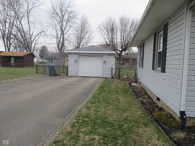 detached garage with driveway and fence